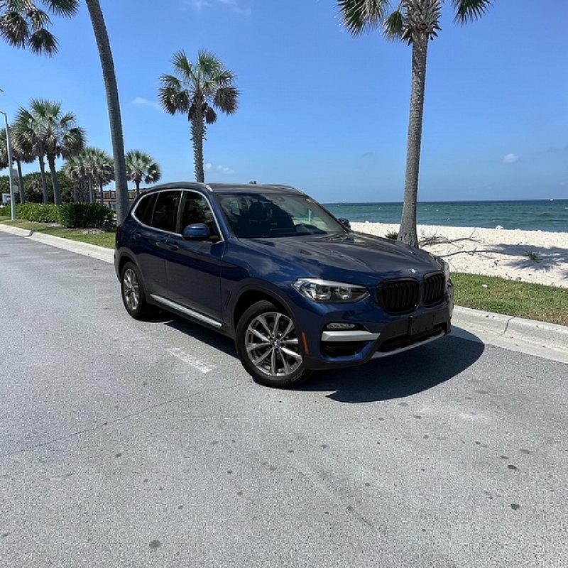 Blue BMW midsize SUV available for rent with MOOV Rentals in South Florida