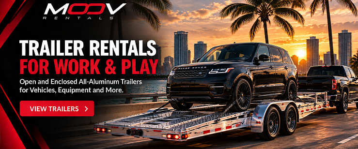 MOOV Rentals high-end all-aluminum open car carrier trailer transporting a vehicle in South Florida